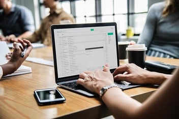 person typing email on laptop